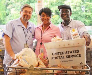 In Glenridge, GA, Letter Carrier David Drawdy, Customer Services Supervisor Tamla Shaw and Letter Carrier Willie Ramsey gather donations.