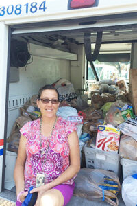Hudson, FL, Rural Carrier Kim Durocher collects food on her route.