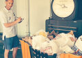 Brockton, MA, Letter Carrier Sean O'Malley weighs a hamper of food donations.