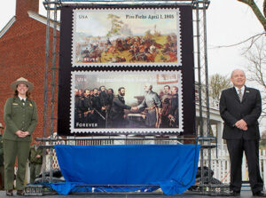 Robin Snyder, acting superintendent, Appomattox Court House National Historical Park, and Pat Mendonca, senior director for the PMG, unveil the stamps.