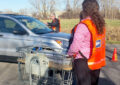 Rochester, NY, Mail Handler Rick Purcio collects mail from a customer while Acting Operations Support Specialist Allison Frischman watches