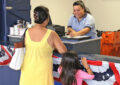 Postal Support Employee Kristen Ancheta helps a customer at the Honolulu Main Post Office’s special “tax shack.”