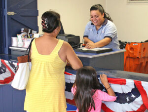 Postal Support Employee Kristen Ancheta helps a customer at the Honolulu Main Post Office’s special “tax shack.”