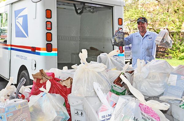 Canajoharie, NY, City Carrier Assistant Dave Diodato collects food during the 2014 Stamp Out Hunger.