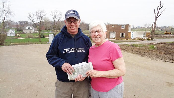 Rochelle, IL, Rural Carrier Joel Reese and a customer whose home was damaged by a tornado