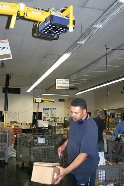 Troy, MI, Retail Distribution Associate Paul Williams uses PASS to scan and mark a parcel for “committed” delivery.