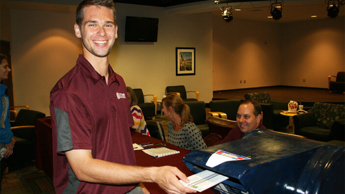 Mississippi State University Student Association Secretary Logan Reeves mails an absentee ballot last week.