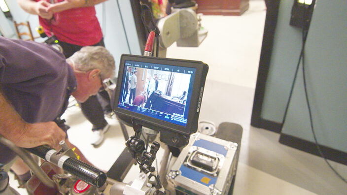 A crew member works behind the scenes on “The Inspectors.”