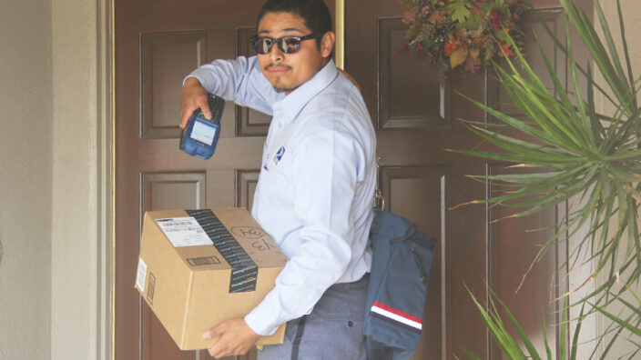 Tustin, CA, City Carrier Assistant Joseph Ramirez deliveries a package in December.