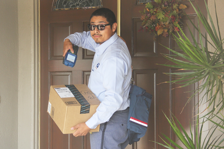 Tustin, CA, City Carrier Assistant Joseph Ramirez deliveries a package in December.