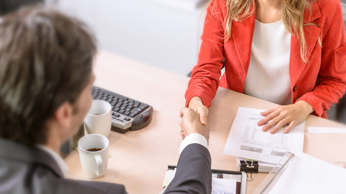 Two people shaking hands.