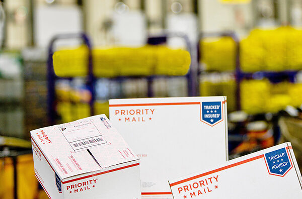 Priority Mail boxes on a workroom floor.