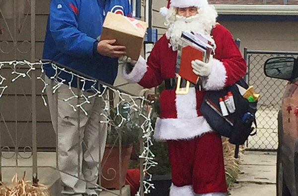 Lansing, IL, City Carrier Tony Reh makes a Christmas delivery.