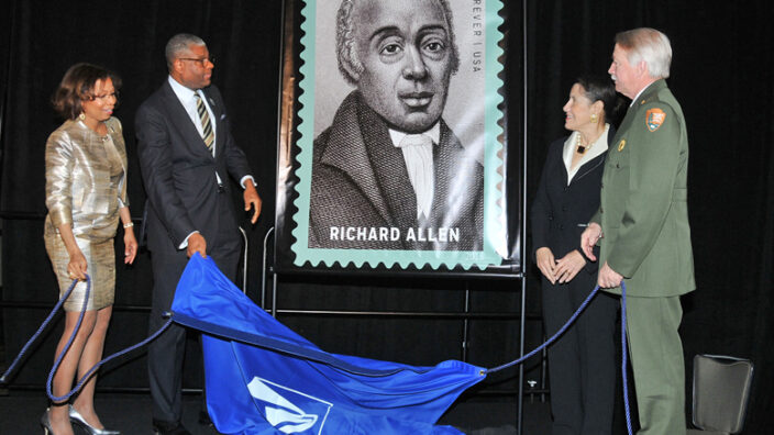 At an Association for the Study of African American Life and History event, DPMG Ron Stroman unveils the stamp with association leaders Sylvia Cyrus and Evelyn Brooks Higginbotham and National Parks Service Director Jonathan Jarvis.