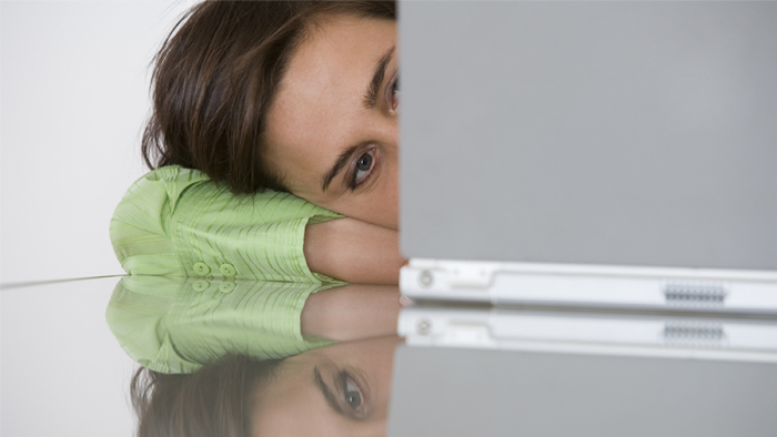 Woman staring at laptop