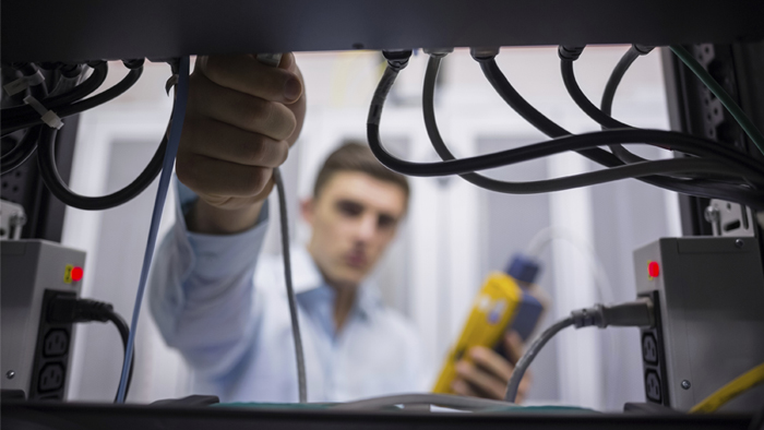 Employee checking network wiring