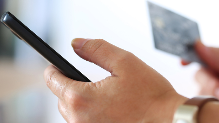 A hand holding a tablet device.