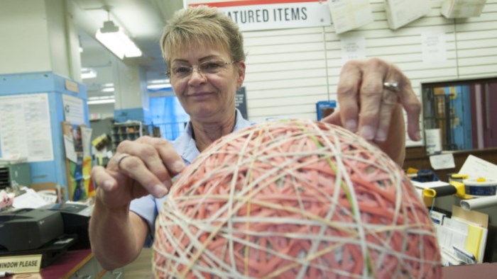 Vancouver, WA, Retail Associate Connie Brown examines her rubber band ball.