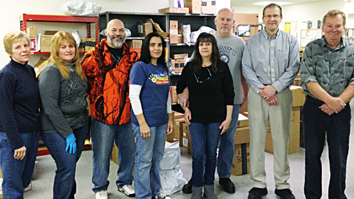 Patricia Tarvin, Kathy Moyer, Henry Rapalo, Irma Rapalo, Donna Bethel, Andy Bethel, Phillip Zimich, and John Haeussler gather at the Pocono Summit, PA, Post Office.