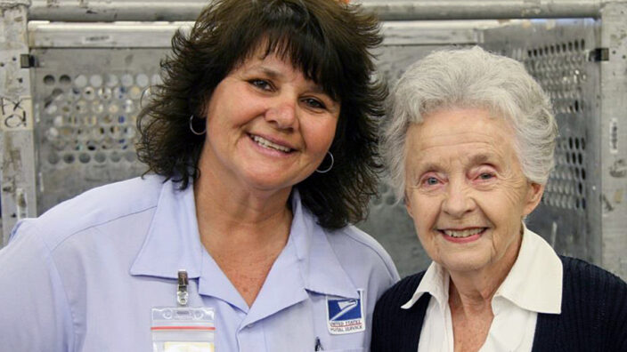 Lakewood, CA, Letter Carrier Marcela MacLean and Marilyn Erickson, the customer’s wife.