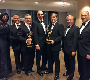 : Pictured from left to right: Inspector JerVay Rogers, Inspector Paul Krenn, Litton Entertainment CEO and creator of the show, Dave Morgan, Inspector in Charge Robert B. Wemyss, Chief Inspector Guy Cottrell, Retired Postal Inspector Dan Mihalko, and Inspector in Charge Pete Rendina.