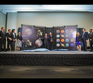 Postal Service leaders, NASA officials and others unveil the stamps.