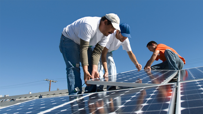 Men installing solar paneling