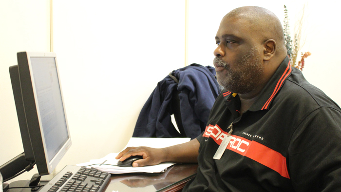 Chicago Letter Carrier James Robinson reviews records in a database, part of a project to boost efficiency.