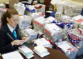 A Guinness World Records adjudicator examines letters collected by DAR members.