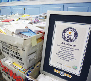 DAR’s Guinness World Records certificate is displayed next to letters that await mailing.