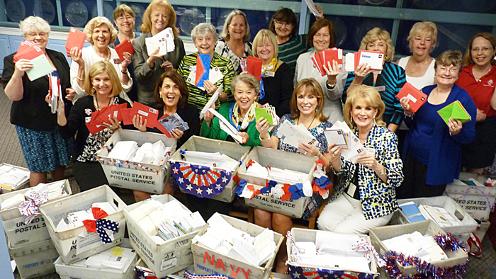 DAR members pose with some of the letters collected for military personnel.