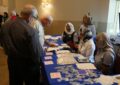 Retail associates greet attendees before the ceremony.