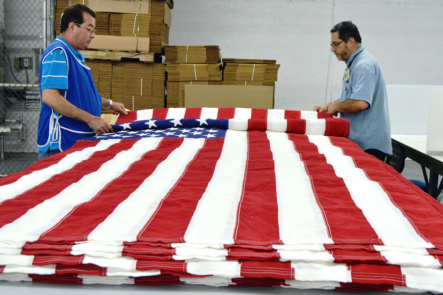 Goodwill workers in Miami create flags this week.