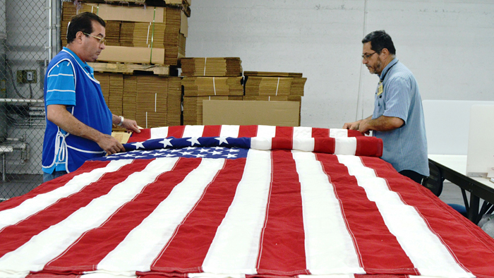 Goodwill workers in Miami create flags this week.