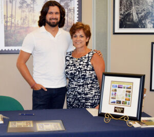 Photographer Paul Marcellini, whose image appears on the Everglades National Park stamp, stands with Customer Relations Coordinator Mirtha Uriarte at the stamp’s dedication in Miami.
