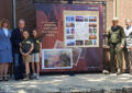 Participants at the Grand Canyon National Park stamp dedication in Arizona include Postmaster Christine Root, USPS Board of Governors Chairman James H. Bilbray and his granddaughters Molly Bilbray-Axelrod and Daisy Bilbray-Kohn, Grand Canyon National Park Commercial Services Chief Douglas Lentz and Chief Postal Inspector Guy Cottrell.