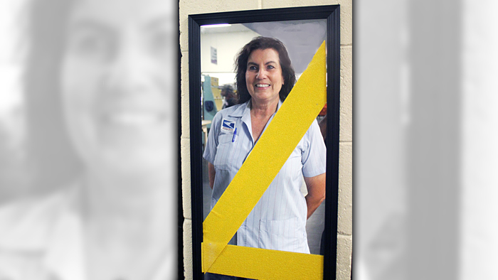 Lawrenceville, GA, Letter Carrier Pat Madincea stands in front of a “safety mirror.”