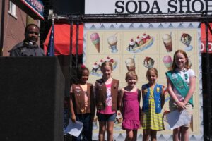 Statom introduces Girl Scout Troop 53, whose members wrote essays about their favorite soda fountain treats. Four of the five chose root beer floats.