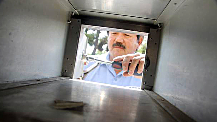 David Garcia changes a lock in Nevada-Sierre District, where he is one of eight maintenance mechanics who change more than 3,000 locks a month.