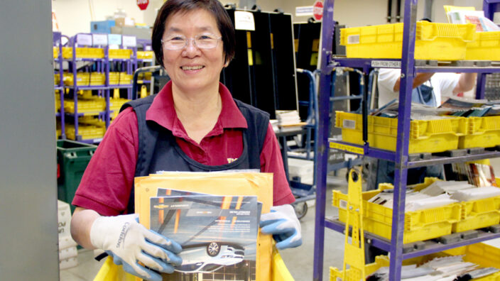 Anaheim, CA, Mail Processing Clerk Donna Ho works with the Flats Sequencing System.