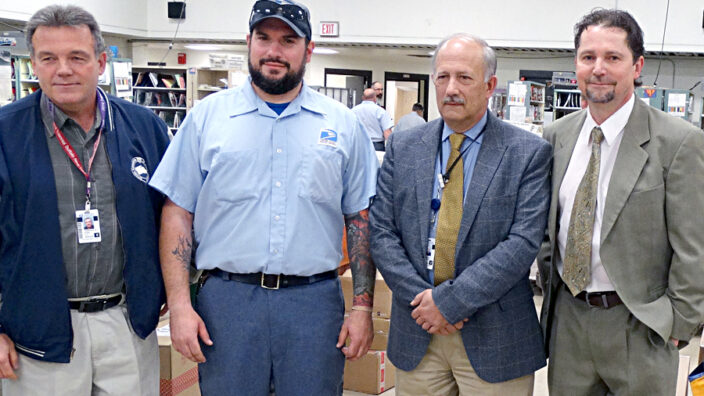 Buffalo, NY, Letter Carrier Joseph Moskal is honored at a recent ceremony. From left: National Association of Letter Carriers Branch 3 President Larry Kania, Moskal, Postmaster Thomas Szklarz and Westside Station Customer Services Manager Paul Urbanski.