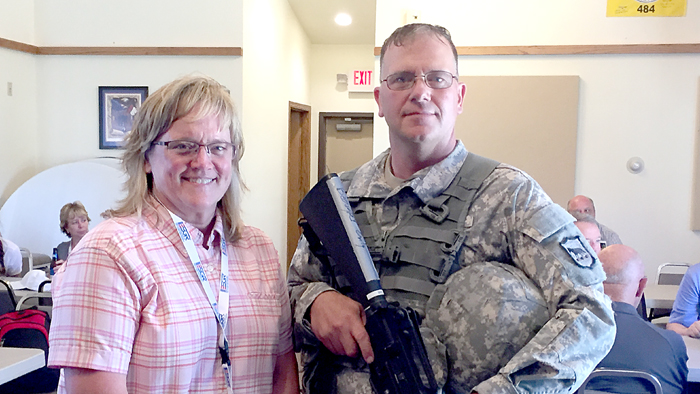 Hot Springs, SD, Postmaster Marcia Kenobbie and Letter Carrier Jeffrey Beougher, a member of the South Dakota National Guard.