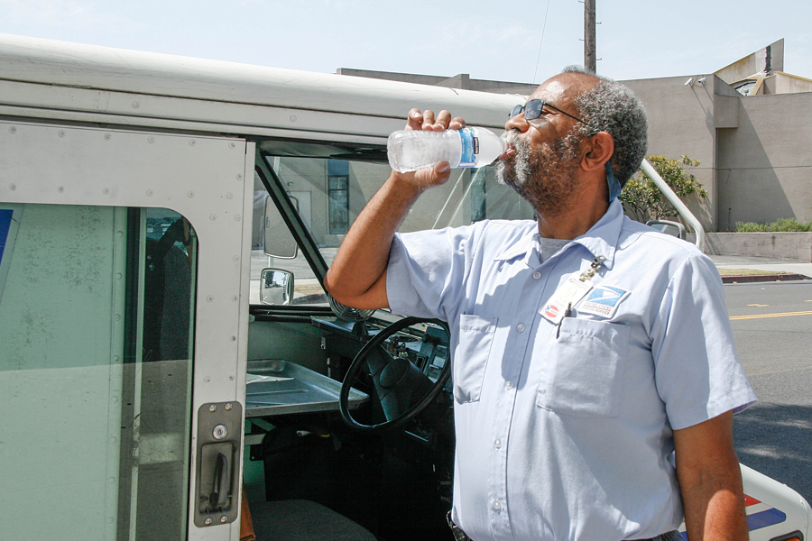 Rancho Park, CA, Letter Carrier Michael Doxley drinks water on a recent hot day.