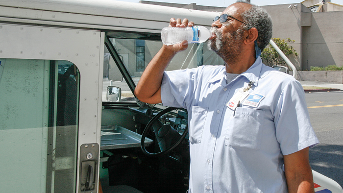 Rancho Park, CA, Letter Carrier Michael Doxley drinks water on a recent hot day.