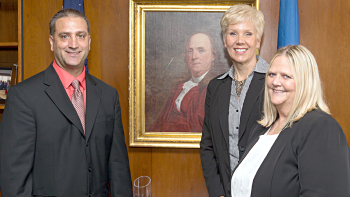 USPS recently honored, from left, Andrew Groll, Penny Miller and Kimberly Fowler for their contributions to Business Connect.