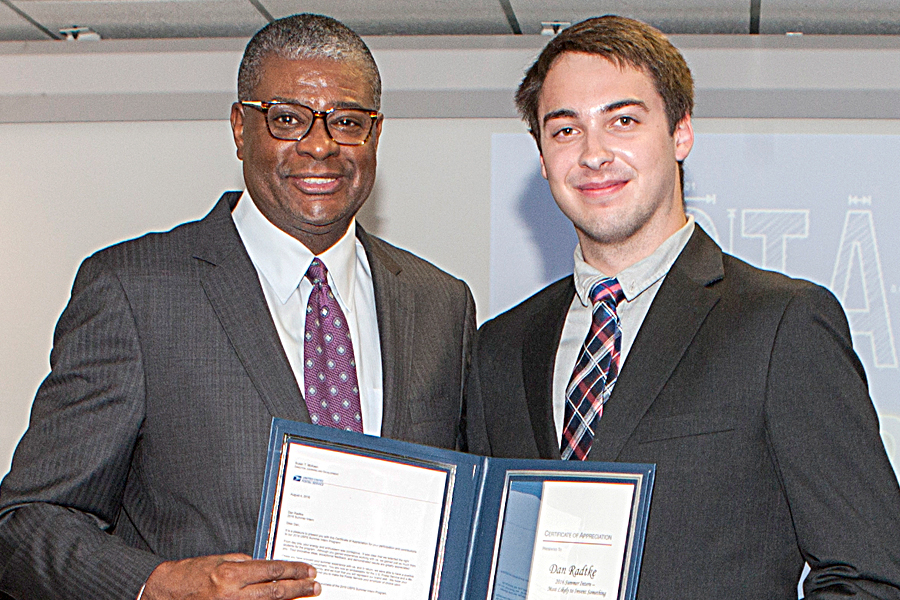 DPMG Ronald A. Stroman presents Engineering Systems intern Dan Radtke with a certificate of appreciation at a recent graduation ceremony for summer interns in Washington, DC.