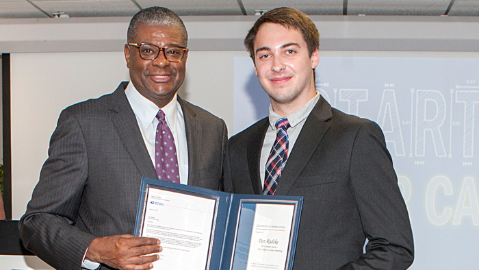 DPMG Ronald A. Stroman presents Engineering Systems intern Dan Radtke with a certificate of appreciation at a recent graduation ceremony for summer interns in Washington, DC.