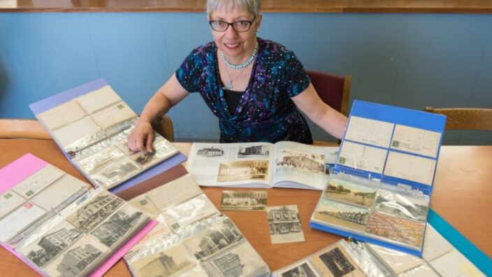 New Jersey librarian Cynthia Harris displays some of her 2,300 postcards. Image: The Jersey Journal