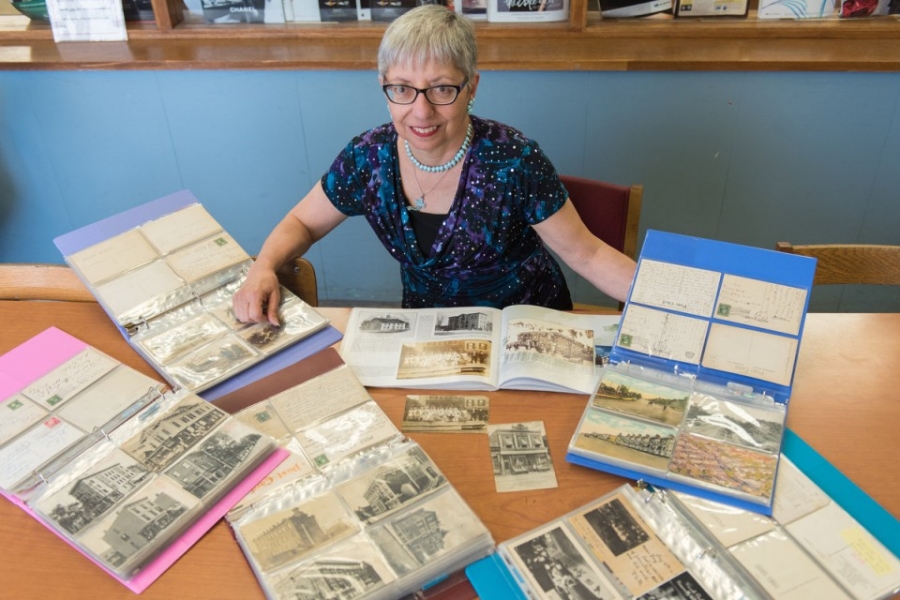 New Jersey librarian Cynthia Harris displays some of her 2,300 postcards. Image: The Jersey Journal
