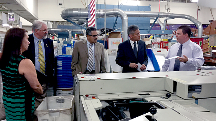 Pennsylvania Department of State Press Secretary Wanda Murren, Dauphin County Elections Director Jerry Feaser, Executive Deputy Secretary Robert Torres and Secretary of State Pedro Cortes are shown how mail is faced and cancelled by Pennsylvania Operations Support Specialist Chad Barto.